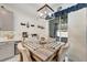 Dining area with sliding door access, decorative chandelier and a table with seating for four at 11637 Woodleaf Dr # 11637, Bradenton, FL 34211