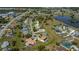 Aerial view of a residential neighborhood featuring homes with pools and well-kept yards near a tranquil lake at 1212 Yachtsman Ln, Punta Gorda, FL 33983