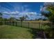 A well-manicured backyard featuring a sturdy black fence, with scenic views of the surrounding landscape at 1212 Yachtsman Ln, Punta Gorda, FL 33983