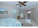 Spacious bedroom featuring a ceiling fan, dresser, and sliding glass doors to the outside patio at 1212 Yachtsman Ln, Punta Gorda, FL 33983