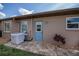 Back exterior featuring a door leading to a cozy patio area and outdoor AC unit at 1212 Yachtsman Ln, Punta Gorda, FL 33983