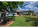 Charming home with a blue garage door, complemented by a well-manicured lawn and decorative landscaping at 1212 Yachtsman Ln, Punta Gorda, FL 33983