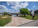 Inviting home featuring a two-car garage, manicured lawn, and paver driveway at 1212 Yachtsman Ln, Punta Gorda, FL 33983