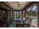 Charming outdoor dining area in screened lanai with glass table overlooking the backyard at 1212 Yachtsman Ln, Punta Gorda, FL 33983