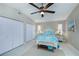 Comfortable bedroom with ceiling fan, tile flooring, and ample closet space at 1212 Yachtsman Ln, Punta Gorda, FL 33983