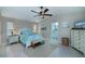 Cozy main bedroom with ceiling fan, tile flooring, and view into the main bathroom at 1212 Yachtsman Ln, Punta Gorda, FL 33983