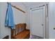 Cozy mud room features a wooden bench, coat rack, and door with charming decorative accents at 1212 Yachtsman Ln, Punta Gorda, FL 33983