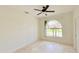 Bedroom featuring neutral walls, travertine tile flooring, and a sunlit arched window at 1259 Royal Tern Dr, Punta Gorda, FL 33950