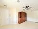 Bright bedroom features a Murphy bed, a ceiling fan, and neutral paint, creating a calm living space at 1259 Royal Tern Dr, Punta Gorda, FL 33950