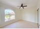 Bright bedroom with large window and ceiling fan, showcasing a peaceful atmosphere at 1259 Royal Tern Dr, Punta Gorda, FL 33950