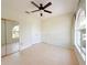 Cozy bedroom featuring a ceiling fan, closet and large window with natural light and tile floors at 1259 Royal Tern Dr, Punta Gorda, FL 33950