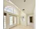 Bright foyer featuring arched windows, decorative glass doors, and light tile flooring leading into the home at 1259 Royal Tern Dr, Punta Gorda, FL 33950