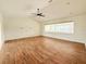 Open living room with wood-look tile flooring and a view of the pool area at 1259 Royal Tern Dr, Punta Gorda, FL 33950