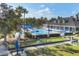 Aerial view of pool, bocce ball, clubhouse, playground and lounging areas at 1578 Scarlett Ave, North Port, FL 34289