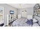 Cozy bedroom with a comfortable bed, white dresser, decorative shelving, and a window for natural light at 1578 Scarlett Ave, North Port, FL 34289