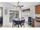 Bright breakfast nook with a glass table, scenic outdoor views and modern ceiling fan fixture at 1578 Scarlett Ave, North Port, FL 34289