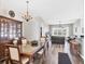 Spacious dining room adjacent to living room featuring hardwood floors and a decorative light fixture at 1578 Scarlett Ave, North Port, FL 34289