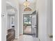 Bright foyer with tile floors and an open doorway leading to a bedroom and wood laminate flooring at 1578 Scarlett Ave, North Port, FL 34289