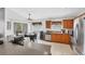 Kitchen with stainless steel appliances, a ceiling fan, wooden cabinetry and a breakfast table at 1578 Scarlett Ave, North Port, FL 34289