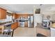 Spacious kitchen with stainless steel appliances, a tiled floor and wooden cabinetry at 1578 Scarlett Ave, North Port, FL 34289