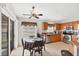 Eat-in kitchen featuring tan tile floors, wooden cabinets, modern appliances and natural light at 1578 Scarlett Ave, North Port, FL 34289