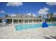 A large community pool with a clubhouse and outdoor seating at 1578 Scarlett Ave, North Port, FL 34289