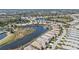 Overhead view of a residential community, featuring a scenic pond surrounded by houses and lush greenery at 1620 Lancashire Dr, Venice, FL 34293