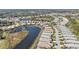 An aerial view of homes situated around a picturesque pond in a well-maintained community at 1620 Lancashire Dr, Venice, FL 34293