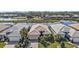 Beautiful aerial shot of a home with a tile roof, lush landscaping, and waterfront views at 1620 Lancashire Dr, Venice, FL 34293