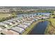 Aerial shot of homes by a lake, featuring screened lanais and well-maintained landscapes at 1620 Lancashire Dr, Venice, FL 34293