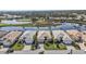 Scenic aerial view of homes bordering a lake and golf course, surrounded by lush greenery at 1620 Lancashire Dr, Venice, FL 34293