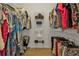 Organized walk-in closet with shelving and hanging space for clothes and accessories at 1620 Lancashire Dr, Venice, FL 34293