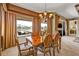 This dining room includes a wood table, seating for six, and views of the lake at 1620 Lancashire Dr, Venice, FL 34293