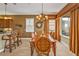 Elegant dining room featuring a chandelier, wooden table, and stylish window shutters at 1620 Lancashire Dr, Venice, FL 34293