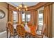 Dining room features a wooden table, decorative chandelier, and views of the water at 1620 Lancashire Dr, Venice, FL 34293