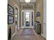 Welcoming foyer with wood flooring, decorative rug, and an elegant cabinet at 1620 Lancashire Dr, Venice, FL 34293