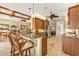 Kitchen featuring granite countertops, a breakfast bar, wood cabinets, and stainless steel appliances at 1620 Lancashire Dr, Venice, FL 34293