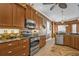 Kitchen showcasing stainless appliances, dark cabinetry, and adjacent dining area at 1620 Lancashire Dr, Venice, FL 34293