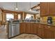 Kitchen featuring stainless steel appliances, a breakfast bar, and wood cabinets at 1620 Lancashire Dr, Venice, FL 34293