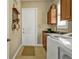 Laundry room featuring a washer and dryer, sink, and storage cabinets at 1620 Lancashire Dr, Venice, FL 34293