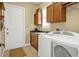 Laundry room featuring a washer and dryer, sink, and storage cabinets at 1620 Lancashire Dr, Venice, FL 34293