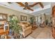 Open-concept living room with a coffered ceiling, comfortable furniture, and seamless flow to other spaces at 1620 Lancashire Dr, Venice, FL 34293