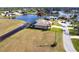 Stunning waterfront property featuring a screened lanai and lush landscaping at 17122 Barcrest Ln, Punta Gorda, FL 33955