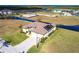 A high-angle shot showcasing a stunning home with solar panels, a three-car garage, and beautiful waterfront scenery at 17122 Barcrest Ln, Punta Gorda, FL 33955