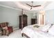 This bedroom features a dark wood four-poster bed, woven chair, and coordinating coastal decor at 17122 Barcrest Ln, Punta Gorda, FL 33955