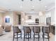 Modern kitchen boasts a spacious island with bar stool seating, stainless steel appliances, and stylish pendant lighting at 17122 Barcrest Ln, Punta Gorda, FL 33955