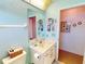 Bright bathroom with a white vanity, nautical decor, and blue walls at 1727 Boca Raton Ct, Punta Gorda, FL 33950