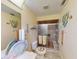 Bathroom with a tiled shower, fish decor and vanity with seashell decorations at 1727 Boca Raton Ct, Punta Gorda, FL 33950