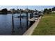 Waterfront view highlighting a private boat lift with convenient access to the canal at 1727 Boca Raton Ct, Punta Gorda, FL 33950