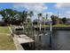 A sturdy boat lift provides direct access to the water from the property's private dock at 1727 Boca Raton Ct, Punta Gorda, FL 33950